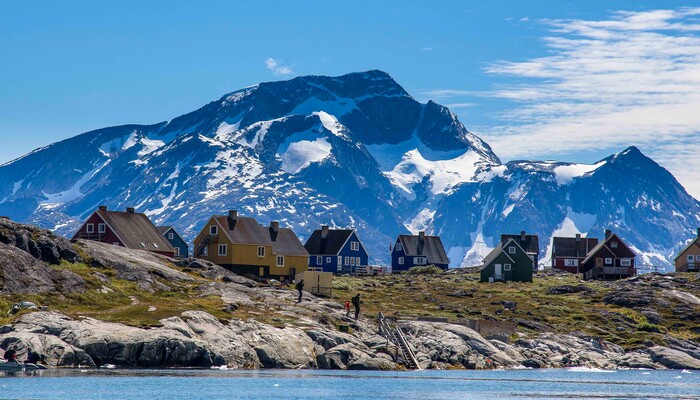 Beautiful view of the city with colorful housesby the blue ocean. Mountains in the background and beautiful blue sky.